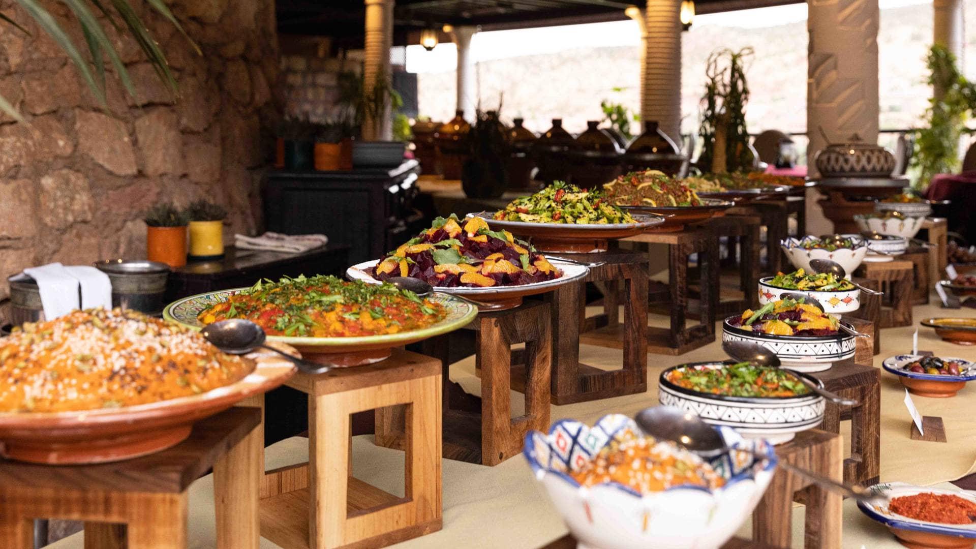 A vibrant display of traditional Moroccan dishes during cooking lessons at Kasbah Tamadot.