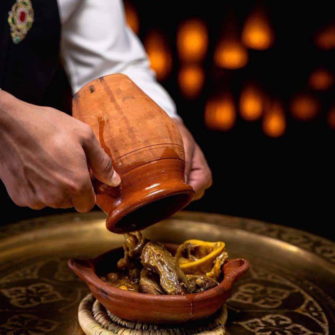 Serving authentic tanjia, a signature dish of Marrakesh's culinary tradition.